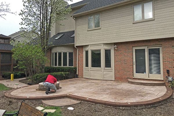 Faded stamped concrete patio in Brantford before sealing