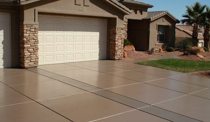 Tan coloured concrete driveway sealed with a semi-gloss finish
