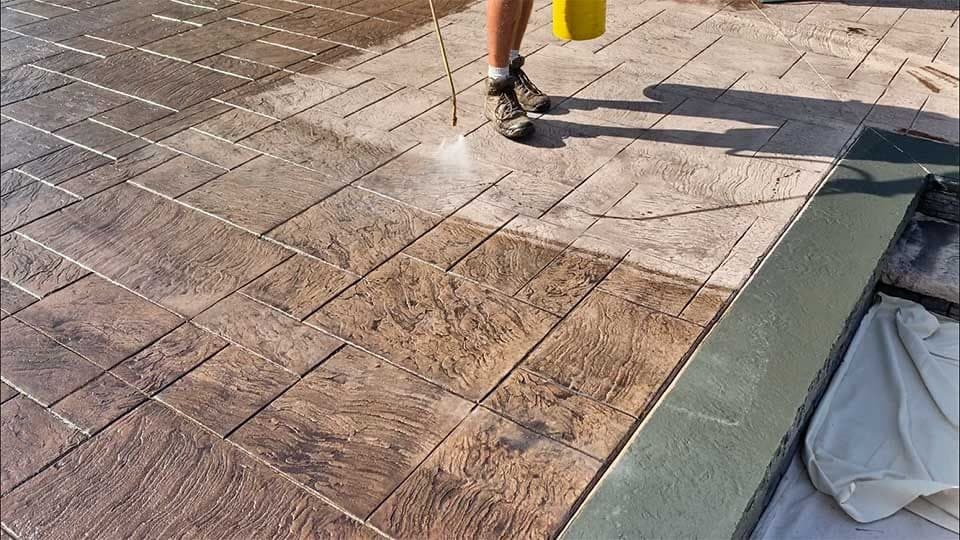 Pressure washing wood-plank stamped concrete before applying sealer