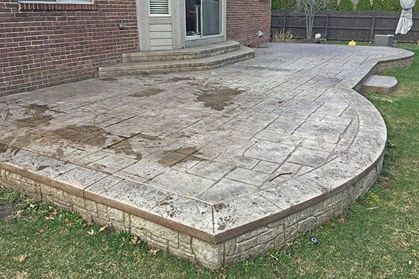 Stained stamped concrete patio in St. Thomas before sealing