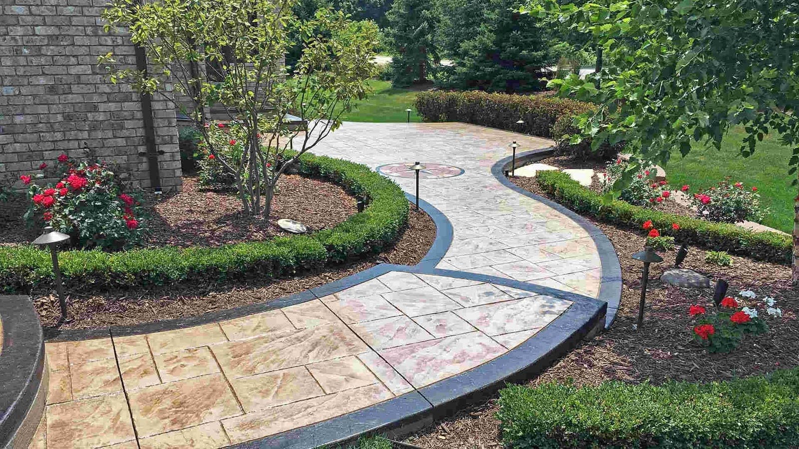 Curved stamped concrete garden walkway with a semi-gloss sealer